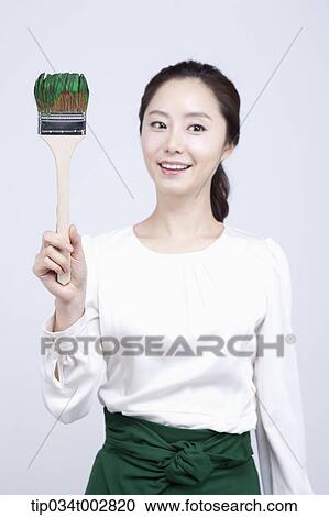 woman holding a paint brush with green paint View Large Photo Image Stock Image - woman holding a paint brush with green paint. Fotosearch