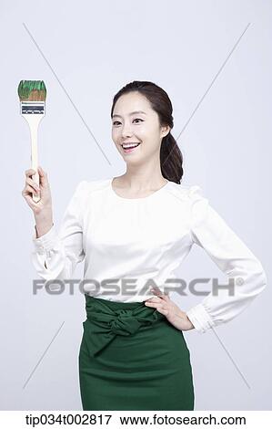 woman holding a paint brush with green paint View Large Photo Image Stock Photo - woman holding a paint brush with green paint. Fotosearch
