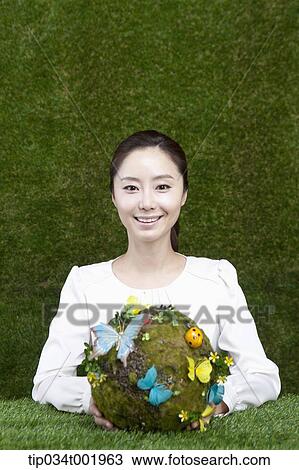 woman holding a sphere covered with colorful butterflies View Large Photo Image Stock Image - woman holding a sphere covered with colorful butterflies . Fotosearch