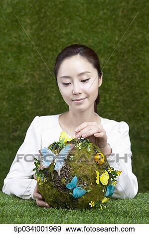 woman holding a sphere covered with colorful butterflies View Large Photo Image Stock Photo - woman holding a sphere covered with colorful butterflies . Fotosearch