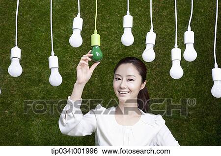 woman holding one the bulbs hanging on the ceiling View Large Photo Image Stock Photograph - woman holding one the bulbs hanging on the ceiling. Fotosearch
