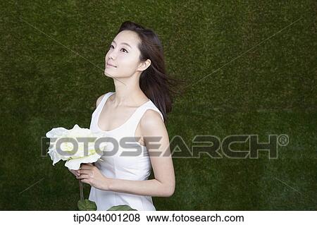 woman holding white flower View Large Photo Image Stock Photo - woman holding white flower. Fotosearch