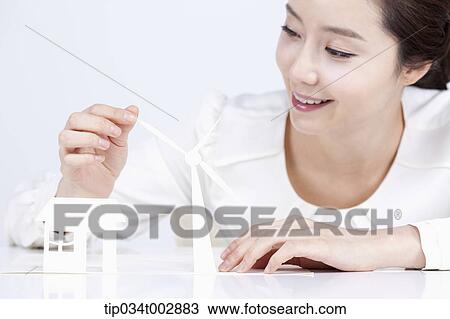 woman looking at the white pinwheel and house model View Large Photo Image Stock Image - woman looking at the white pinwheel and house model. Fotosearch