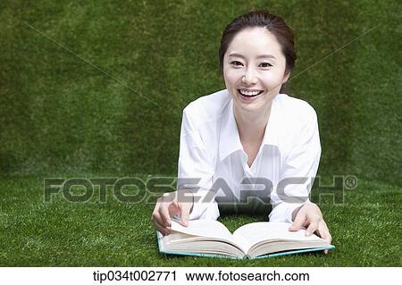 woman lying face and reading a book View Large Photo Image Stock Image - woman lying face and reading a book. Fotosearch