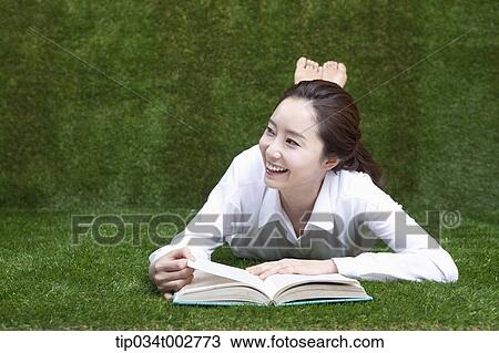 woman lying face and reading a book View Large Photo Image Stock Image - woman lying face and reading a book. Fotosearch