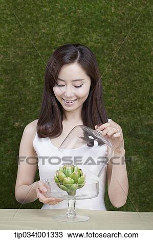 woman opening a crystal box of a plant View Large Photo Image Stock Image - woman opening a crystal box of a plant . Fotosearch