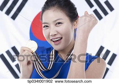 woman showing off a medal in front of the Korean national flag View Large Photo Image Stock Image - woman showing off a medal in front of the Korean national flag. Fotosearch