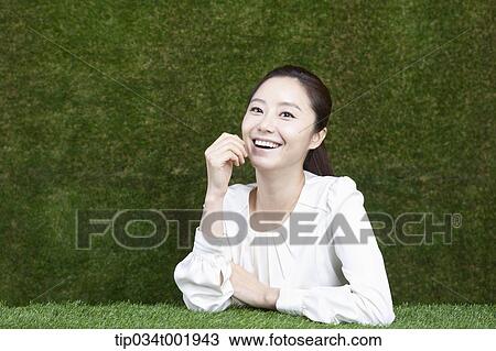 woman sitting and smiling with her chin propped on her hands View Large Photo Image Stock Image - woman sitting and smiling with her chin propped on her hands. Fotosearch