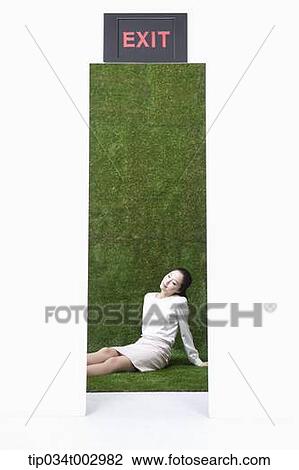 Stock Image - woman sitting in the floor behind the exit. Fotosearch