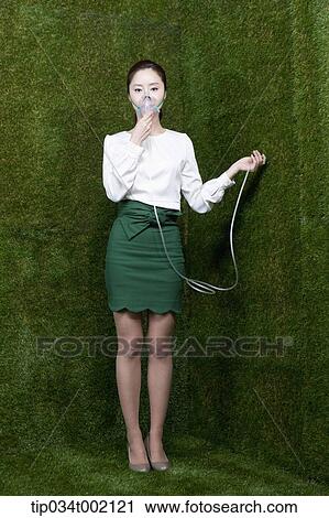 Stock Image - woman wearing respirator. Fotosearch