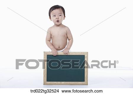 A baby holding a blackboard View Large Photo Image Picture - A baby holding a blackboard. Fotosearch