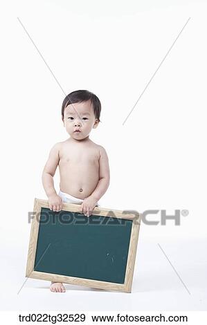 A baby holding a blackboard View Large Photo Image Stock Photo - A baby holding a blackboard. Fotosearch