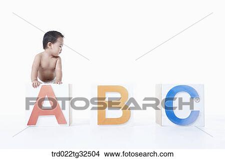 Picture - A baby in the ABC boxes. Fotosearch