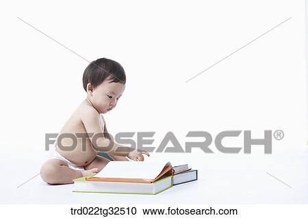 A baby sitting around the books View Large Photo Image Stock Image - A baby sitting around the books. Fotosearch