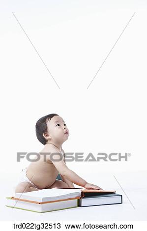 A baby sitting around the books View Large Photo Image Stock Image - A baby sitting around the books. Fotosearch