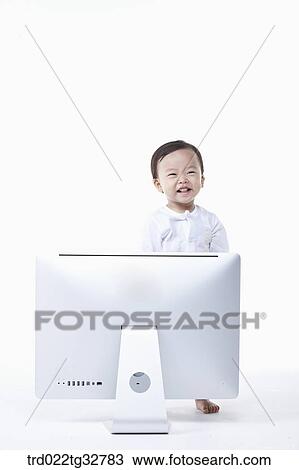 Stock Image - A baby standing with the monitor. Fotosearch