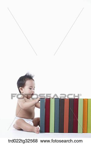 A baby touching on the books View Large Photo Image Stock Photo - A baby touching on the books. Fotosearch