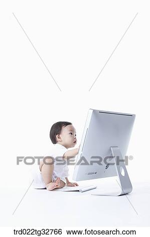 A baby touching on the monitor View Large Photo Image Stock Photograph - A baby touching on the monitor. Fotosearch