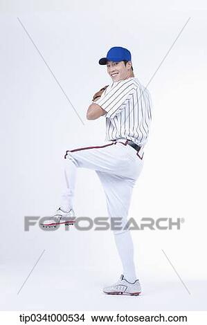 Picture - A baseball player pitching a ball. Fotosearch