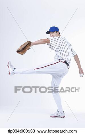Stock Image - A baseball player pitching a ball. Fotosearch
