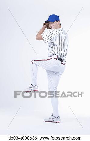 A baseball player pitching a ball View Large Photo Image Stock Photography - A baseball player pitching a ball. Fotosearch