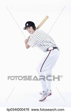 Stock Photograph - A baseball player swing the bat. Fotosearch