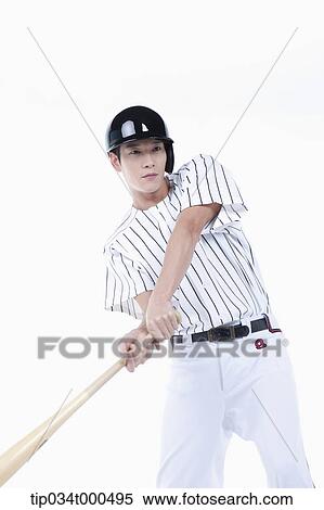 Stock Photography - A baseball player swing the bat. Fotosearch