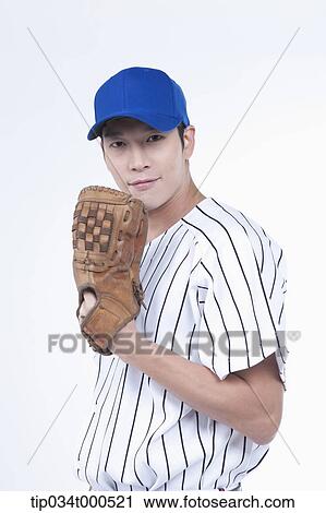 Stock Image - A baseball player wearing a glove. Fotosearch