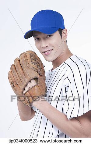 Stock Image - A baseball player wearing a glove. Fotosearch