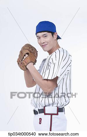 Stock Image - A baseball player wearing a glove. Fotosearch