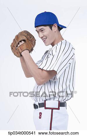 Stock Image - A baseball player wearing a glove. Fotosearch