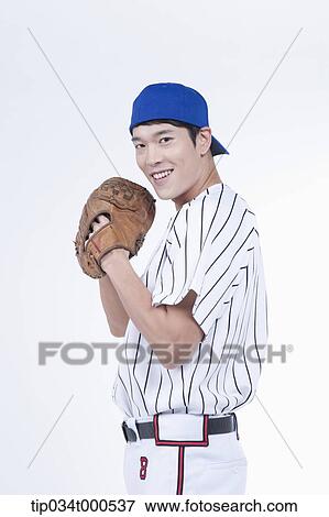 Stock Photo - A baseball player wearing a glove. Fotosearch