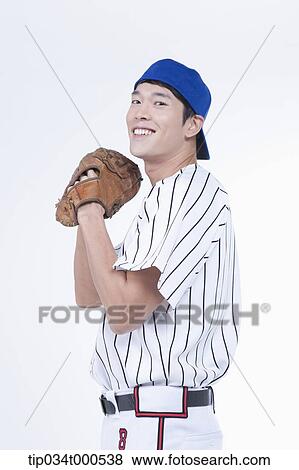 Stock Photo - A baseball player wearing a glove. Fotosearch