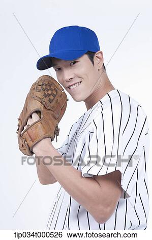 Stock Photograph - A baseball player wearing a glove. Fotosearch