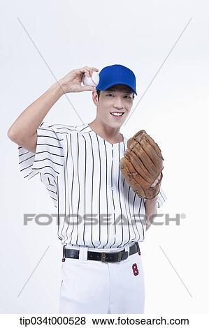 Stock Photo - A baseball player with a ball and glove. Fotosearch
