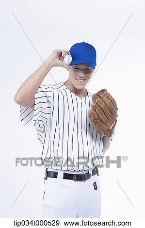 Stock Photo - A baseball player with a ball and glove. Fotosearch
