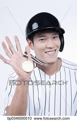 Stock Image - A baseball player with gold medal. Fotosearch