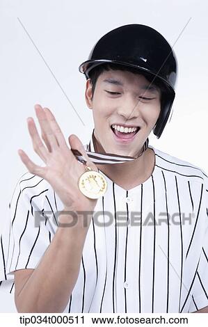A baseball player with gold medal View Large Photo Image Stock Image - A baseball player with gold medal. Fotosearch