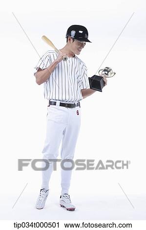 Stock Image - A baseball player with gold trophy. Fotosearch