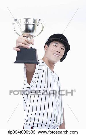 A baseball player with gold trophy View Large Photo Image Stock Image - A baseball player with gold trophy. Fotosearch