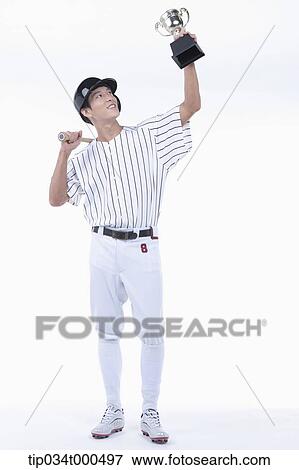 A baseball player with gold trophy View Large Photo Image Stock Photo - A baseball player with gold trophy. Fotosearch