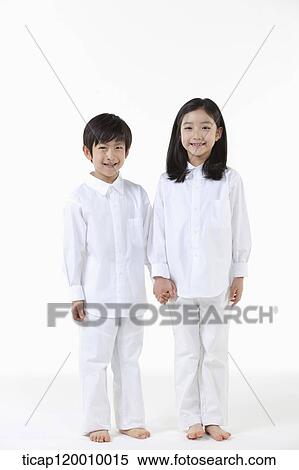 Stock Photography - A boy and girl holding hands together. Fotosearch
