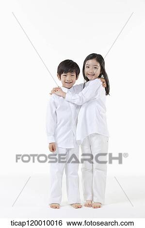 Stock Photograph - A boy and girl putting arms around on. Fotosearch