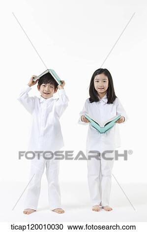 Stock Image - A boy and girl reading a book. Fotosearch
