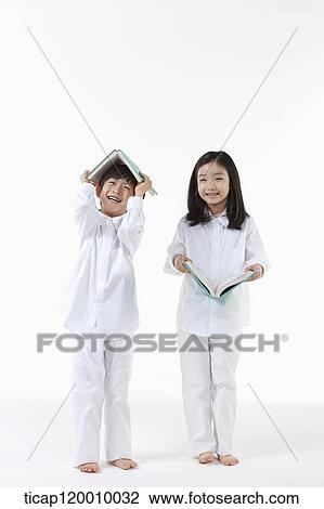 A boy and girl reading a book View Large Photo Image Stock Image - A boy and girl reading a book. Fotosearch