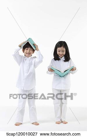 A boy and girl reading a book View Large Photo Image Stock Photo - A boy and girl reading a book. Fotosearch
