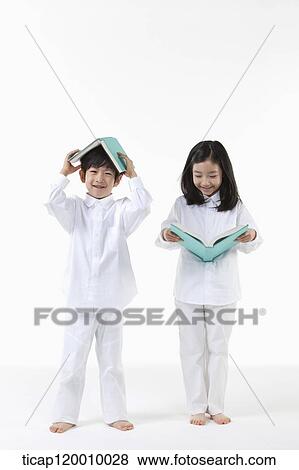Stock Photo - A boy and girl reading a book. Fotosearch