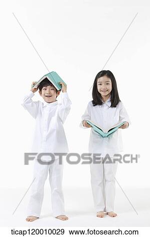 Stock Photo - A boy and girl reading a book. Fotosearch