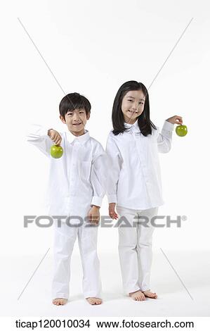 A boy and girl with green apple View Large Photo Image Picture - A boy and girl with green apple . Fotosearch