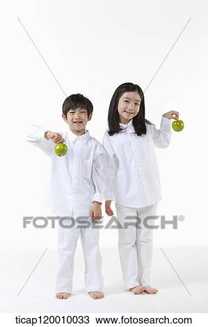 A boy and girl with green apple View Large Photo Image Stock Image - A boy and girl with green apple . Fotosearch